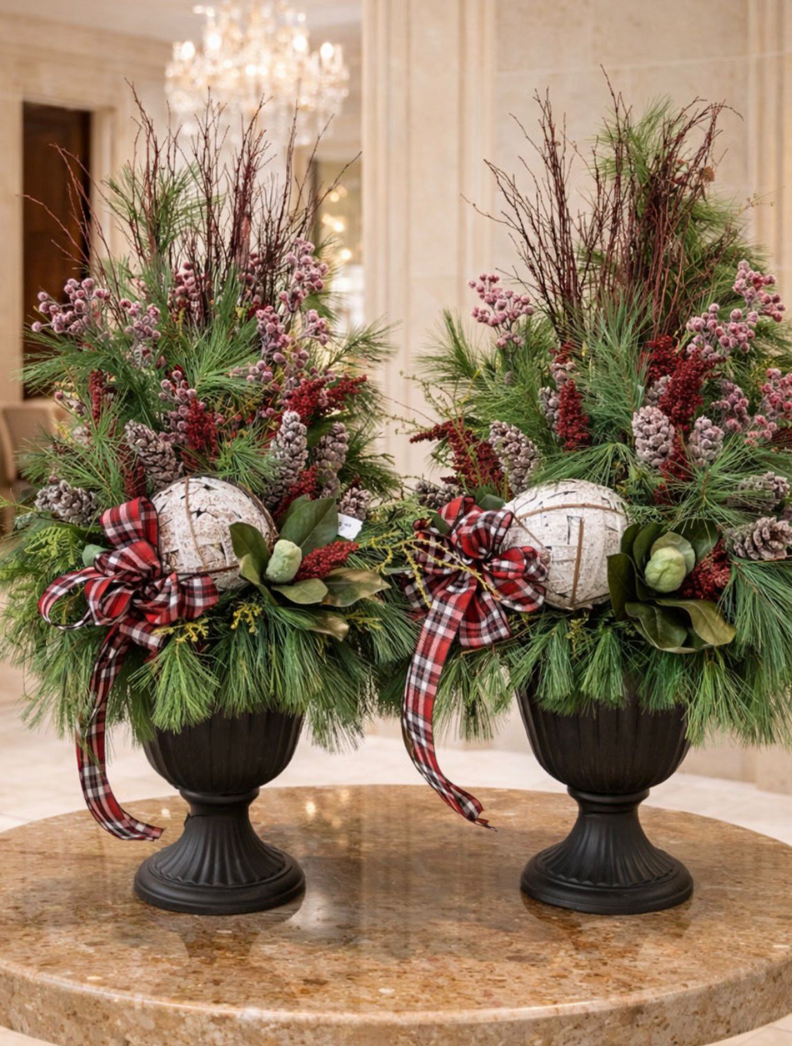 Pair of festive urn arrangements with plaid bows